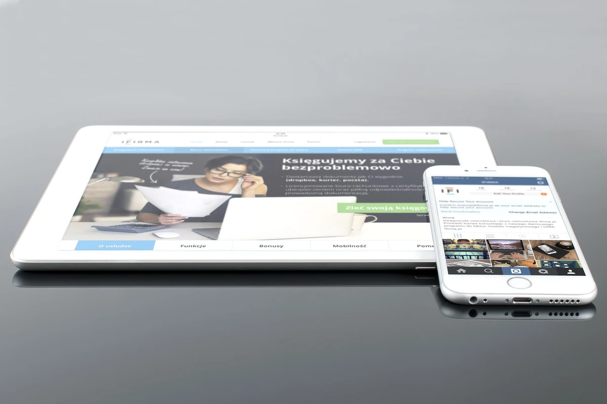 Tablet i smartfon z treściami internetowymi na błyszczącej powierzchni